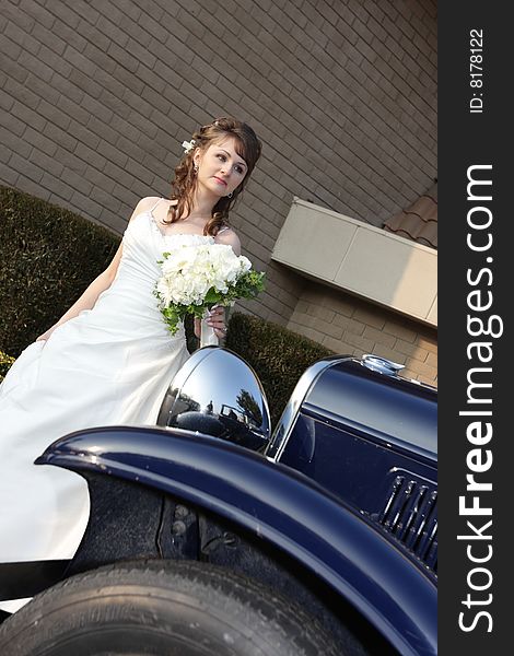 Portrait of bride behind a retro car. Portrait of bride behind a retro car