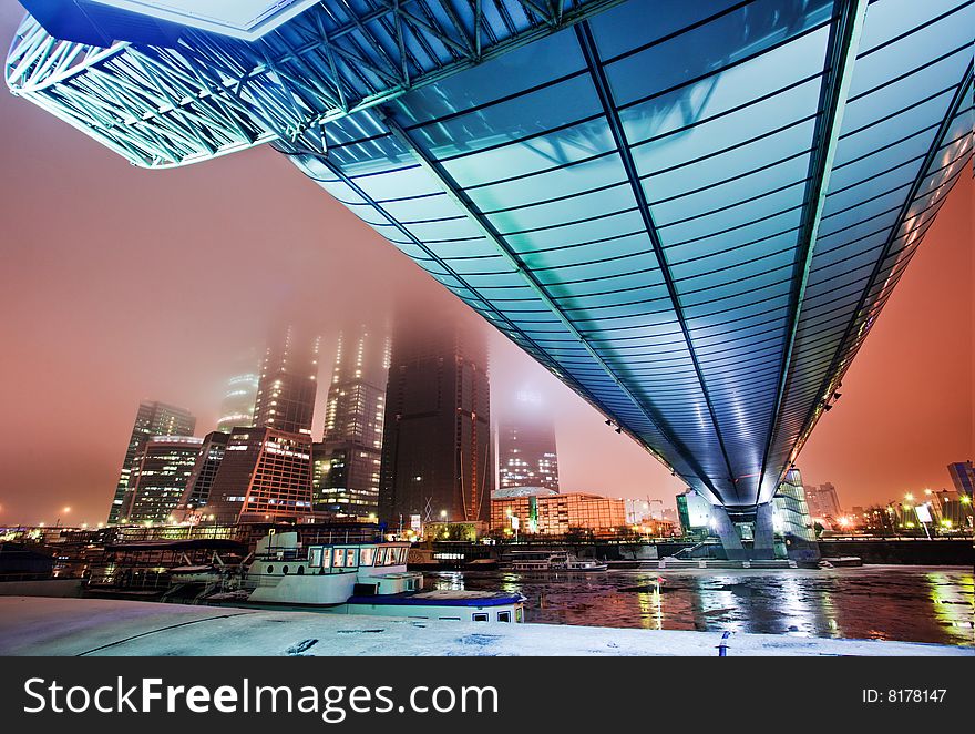 Blue Bridge Over A River In The Evening