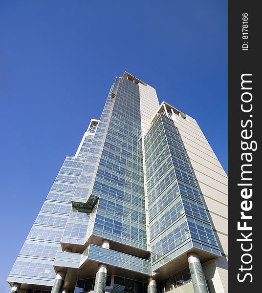 Modern business building over the clear blue sky. Modern business building over the clear blue sky.