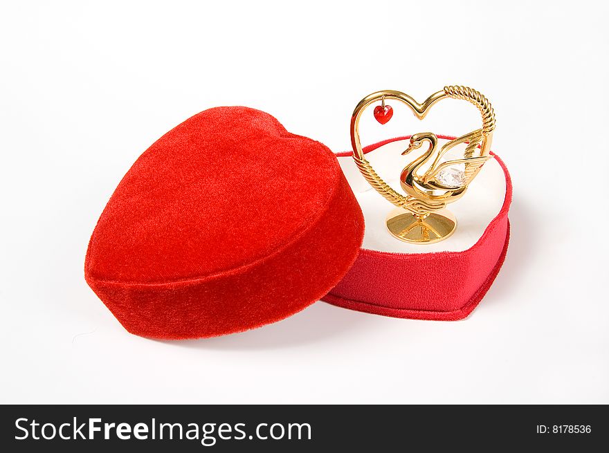 Heart shaped red gift box with lovely statuette, isolated on white. Heart shaped red gift box with lovely statuette, isolated on white