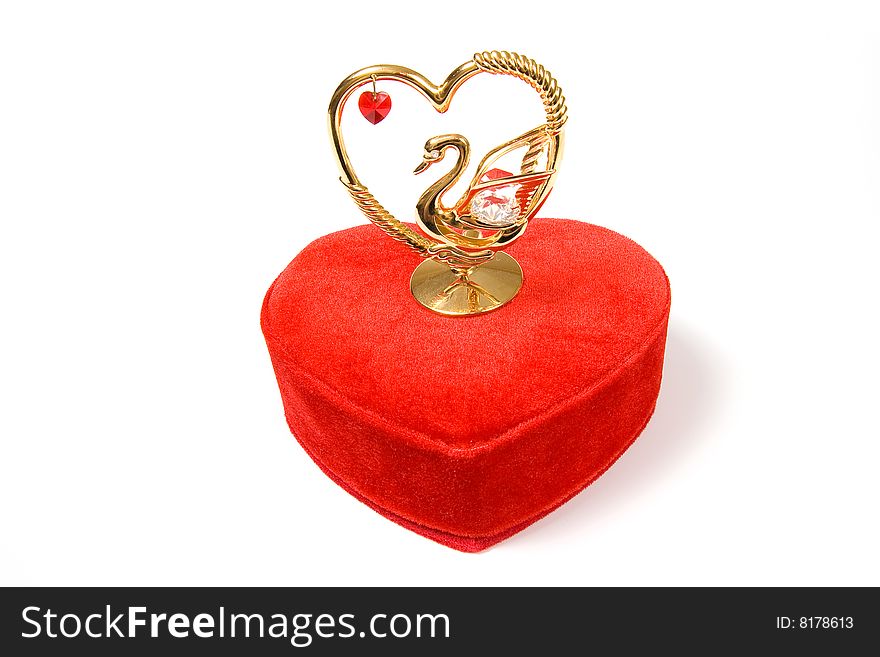 Heart shaped red gift box with lovely statuette, isolated on white. Heart shaped red gift box with lovely statuette, isolated on white