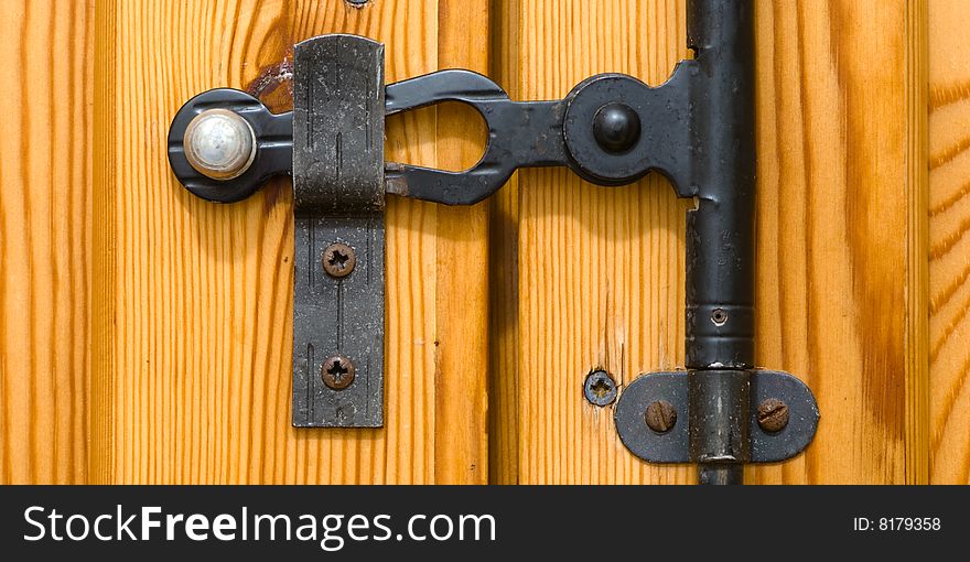 Wooden door metal lock closeup. Wooden door metal lock closeup