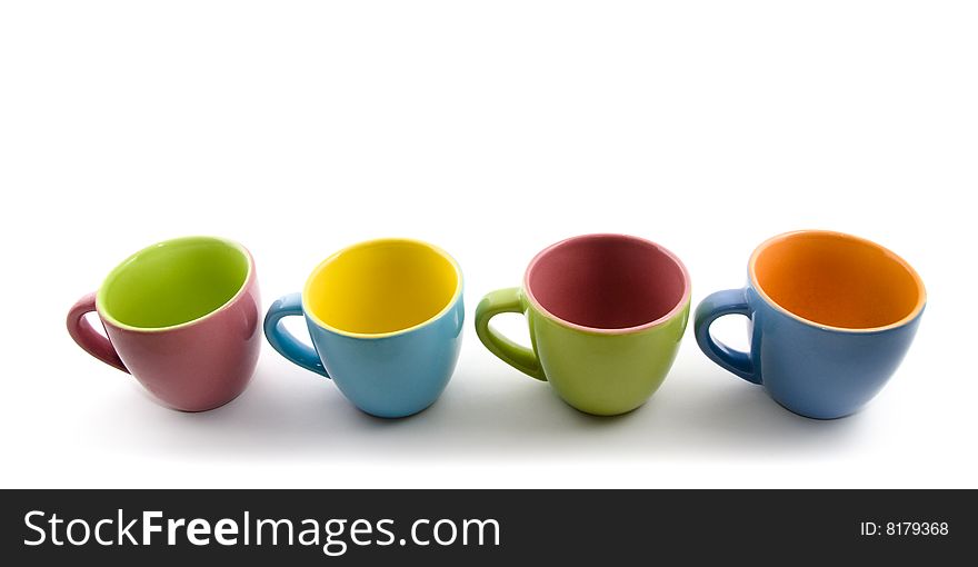 Colored cups aligned on white background