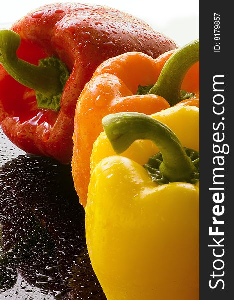 Three Bell Peppers on Wet Surface