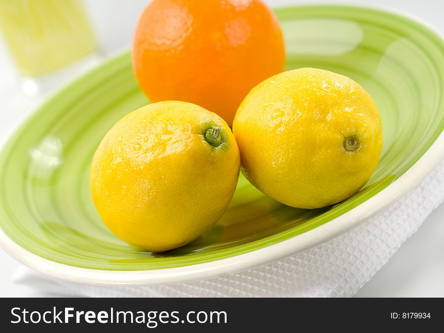Orange and lemons on a green place setting. Orange and lemons on a green place setting