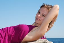 Beautiful Blonde Lying On The Rock Royalty Free Stock Photos