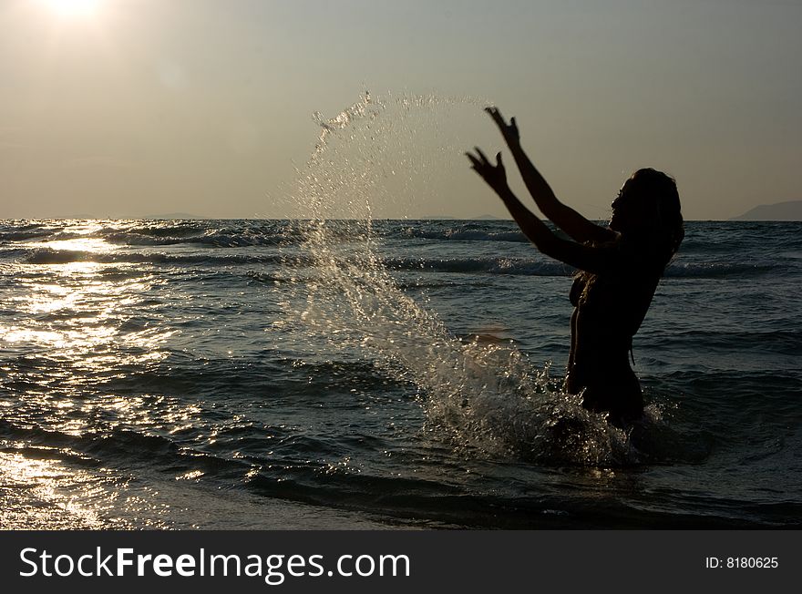 Girl making splashes in the sea
