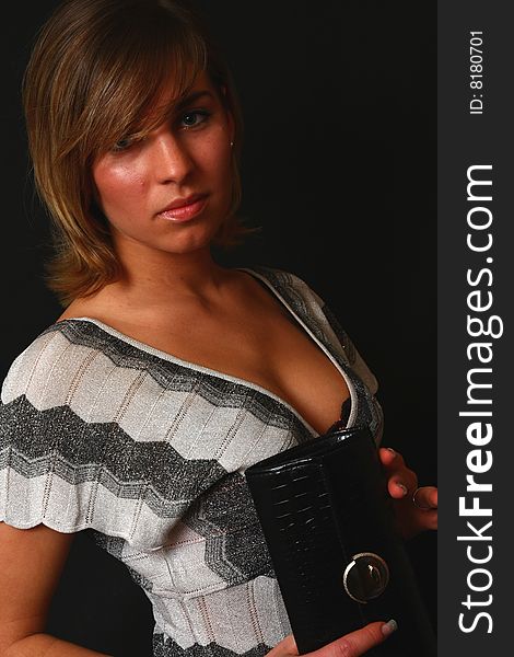 Young and elegant woman in the soft studio light on black background