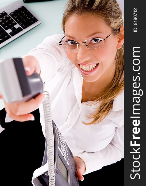 Top view of smiling businesswoman offering call in an office