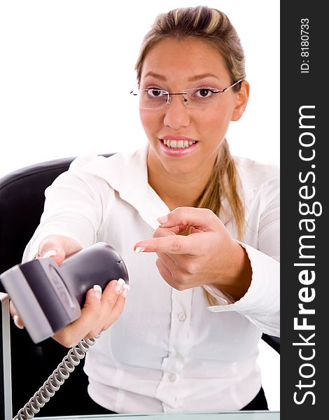Front view of smiling executive pointing at phone with white background