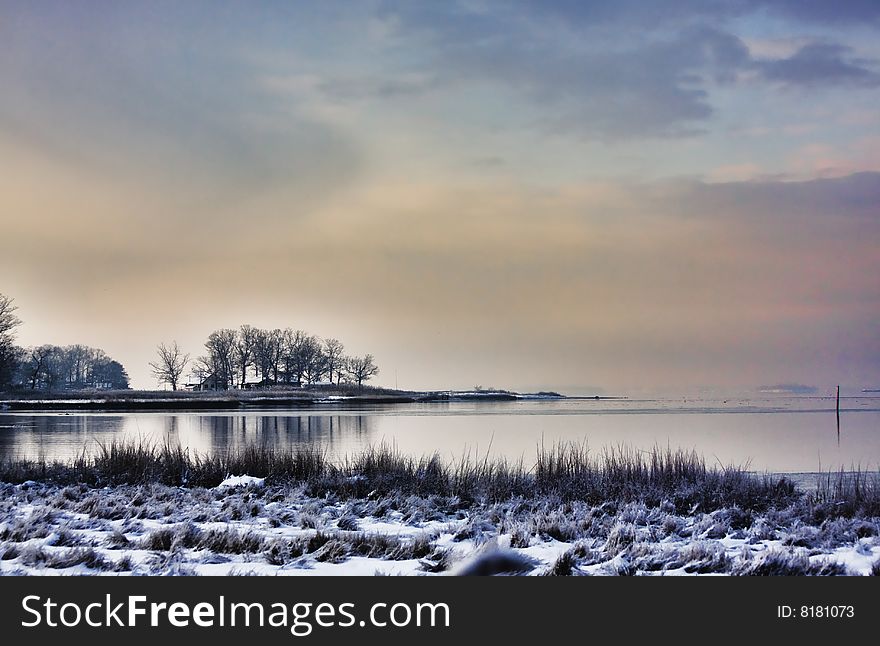 View of calm sea on a winter morning after a snowfall.