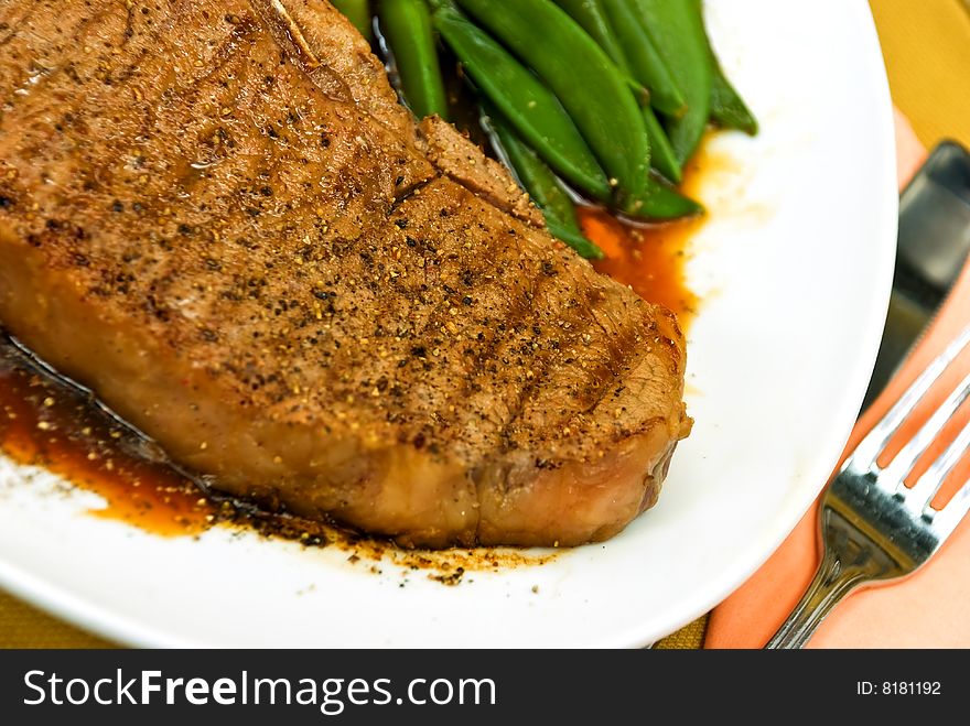 T-Bone Steak with fresh green beans and red Potatoes.