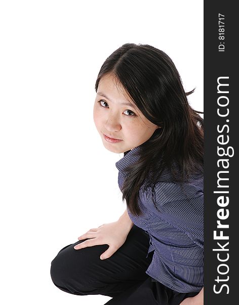 Young chinese girl squatting on the floor isaolted over white