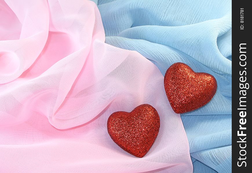 two red hearts on a silk fabric