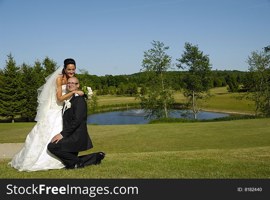 Groom is on his knee of his bride. Groom is on his knee of his bride