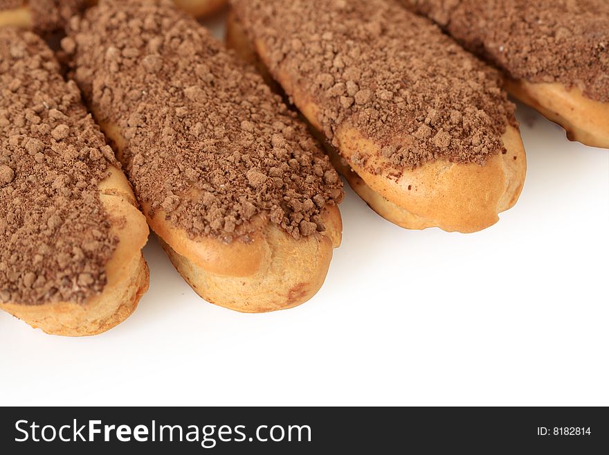 Close-up of four fresh eclairs isolated on white background