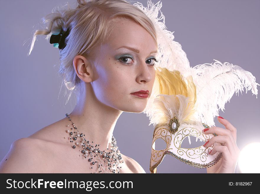 Beautiful young woman with Venetian mask, studio photo. Beautiful young woman with Venetian mask, studio photo