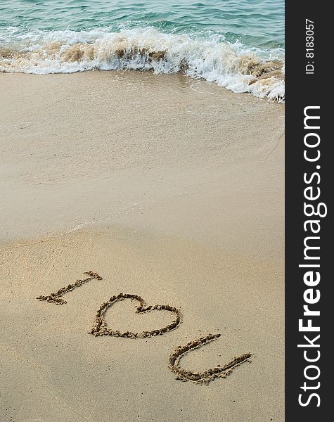 Love Message left in a sandy beach