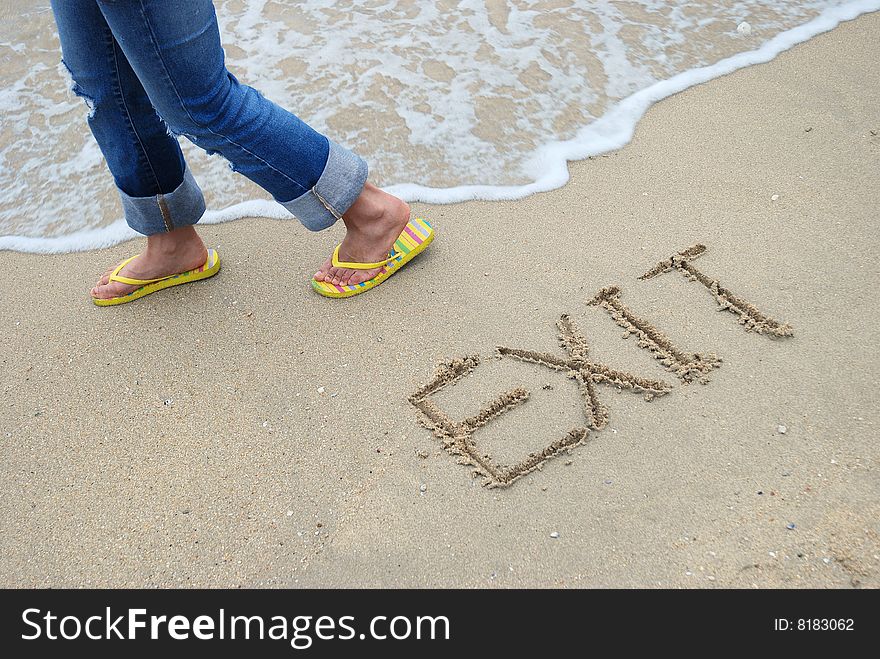 Exit Sign Written in the sandy beach