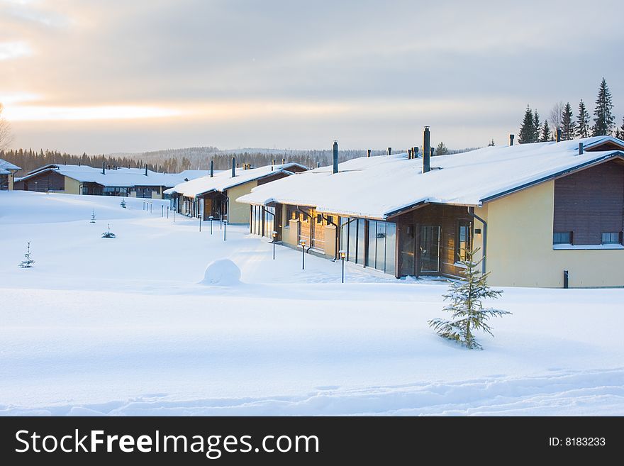 Winter landscape with cottages covered by snow. Sunset. Winter landscape with cottages covered by snow. Sunset.