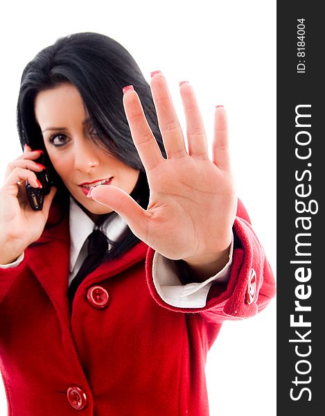 American woman interacting on cell phone and showing stopping gesture against white background