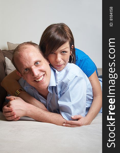 Beautiful young couple on a couch in their new appartment. Beautiful young couple on a couch in their new appartment.