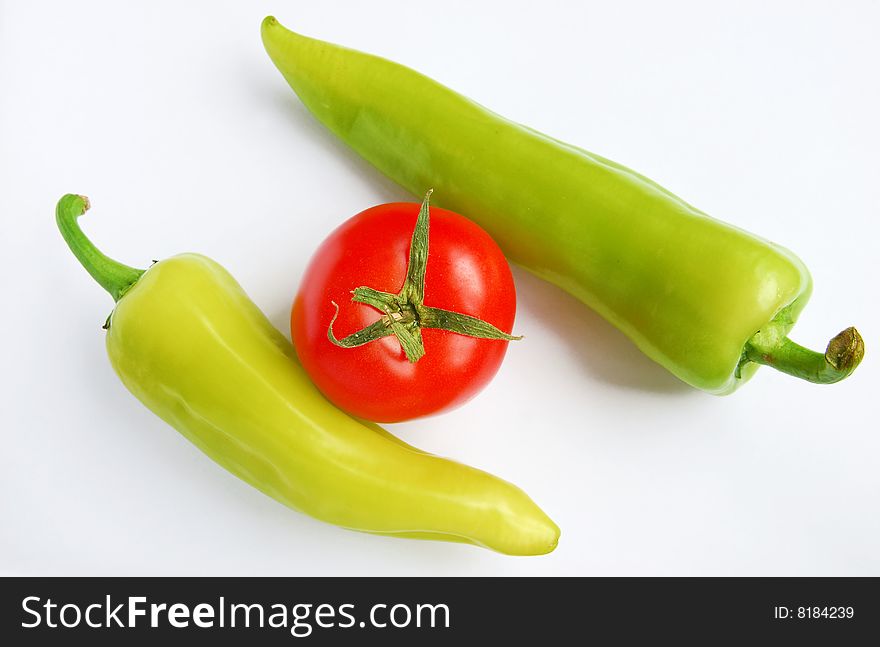 Isolated peppers and tomato on white background. Isolated peppers and tomato on white background
