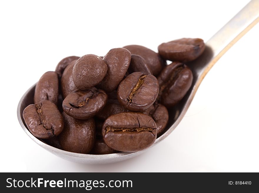 Coffee beans with spoon isolated on white