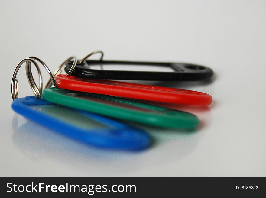Red, blue, black and green blank key tags isolated
