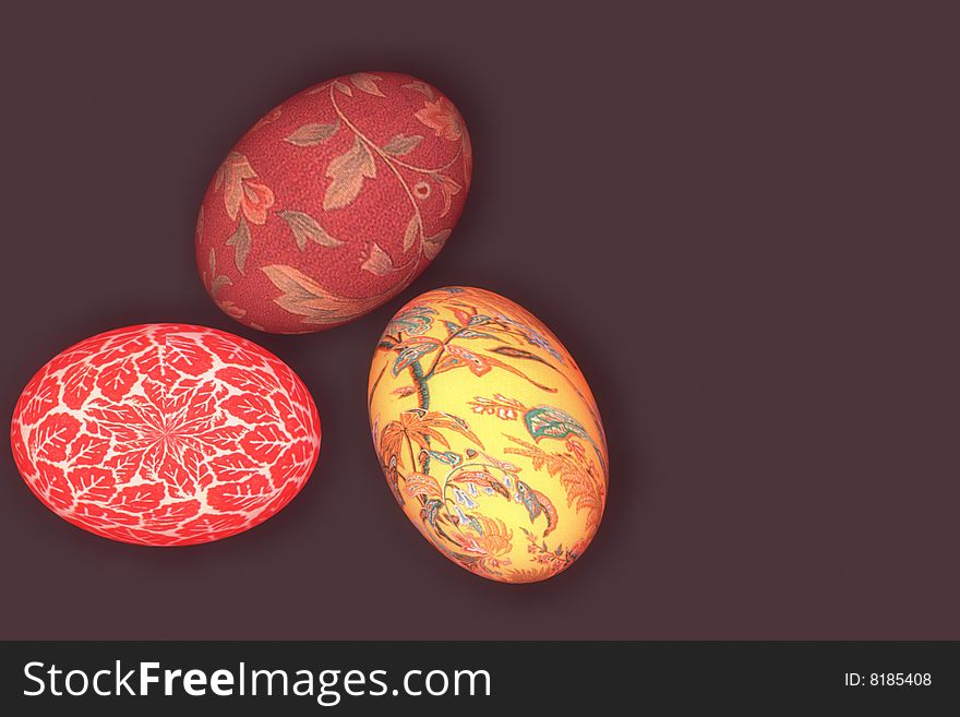 Three eggs on brown background