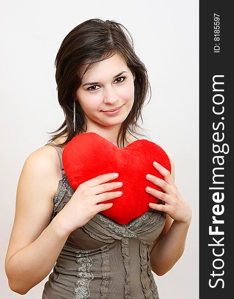 Young girl fashion portrait in studio with plush heart. Young girl fashion portrait in studio with plush heart
