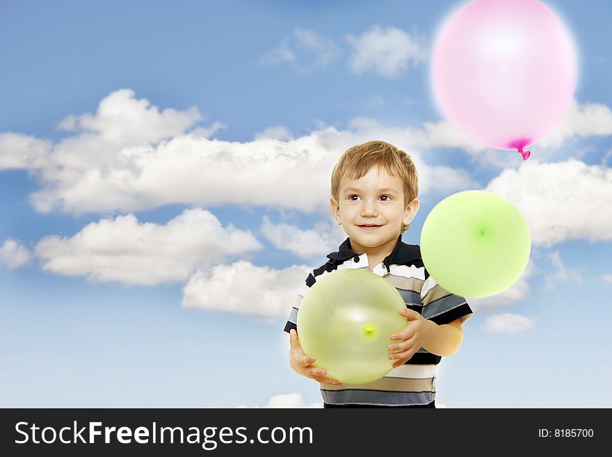Happy boy with colorful balloons over bright sky background