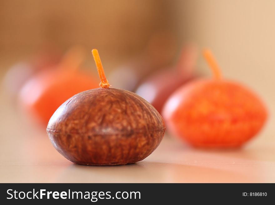 Brown red and orange candlesticks on bathroom shelf