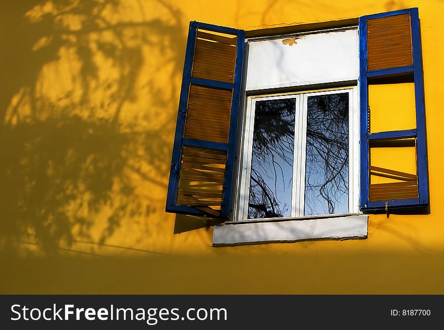 Fragment of yellow wall and old window