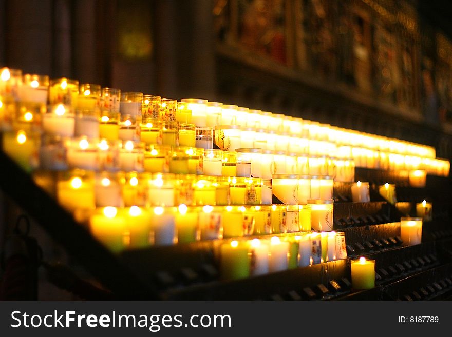 Votive candles lit inside cathedral