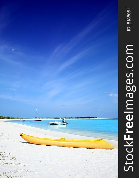 Yellow canoe on a tropical beach