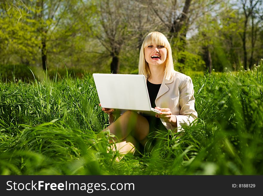 Laughing girl with laptop outdoors. Laughing girl with laptop outdoors