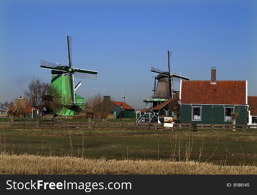 “De Kat” Paint Mill, for grinding pigments for the manufacturing of paint and the green coloredWood Sawing Mill Paltrok or post mill 'De Gekroonde Poelenburg', Zaanse huizen, decorated with typical Zaans green colored paint. “De Kat” Paint Mill, for grinding pigments for the manufacturing of paint and the green coloredWood Sawing Mill Paltrok or post mill 'De Gekroonde Poelenburg', Zaanse huizen, decorated with typical Zaans green colored paint