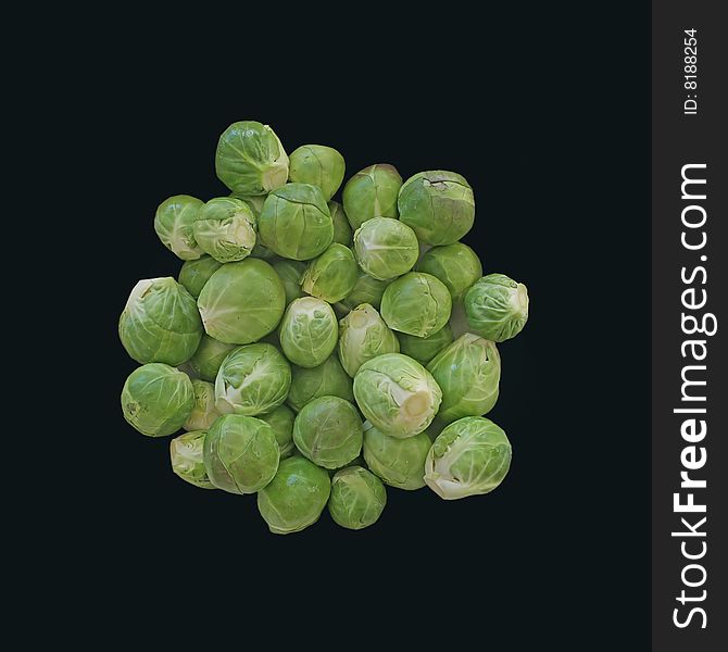 Fresh, raw, green brussels sprouts on black background