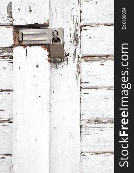 Padlock on an old white wooden gateway. Padlock on an old white wooden gateway