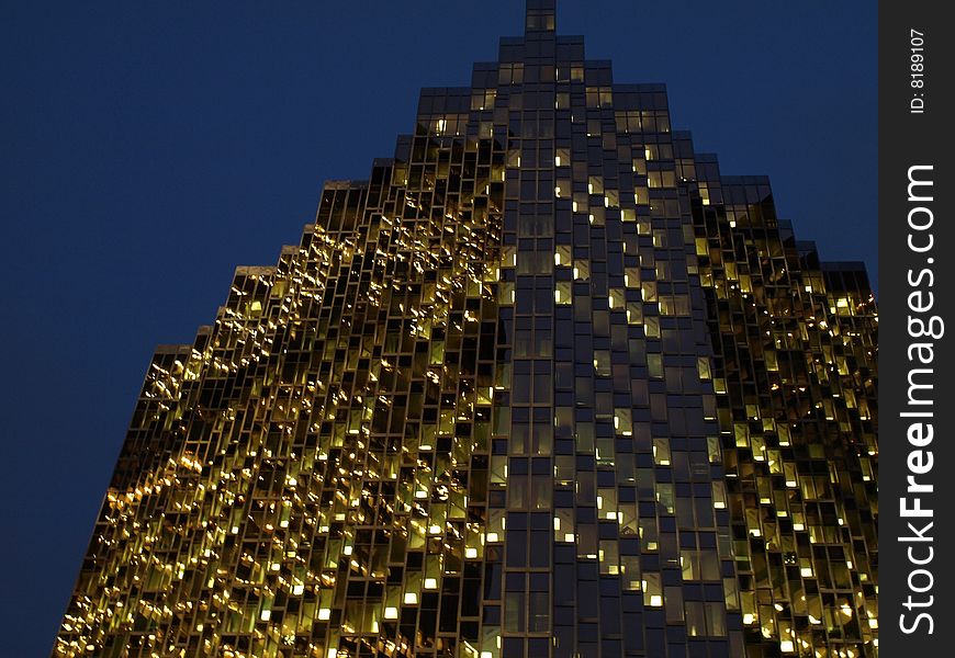 Looking up at the windows of a skyscraper at night. Looking up at the windows of a skyscraper at night.