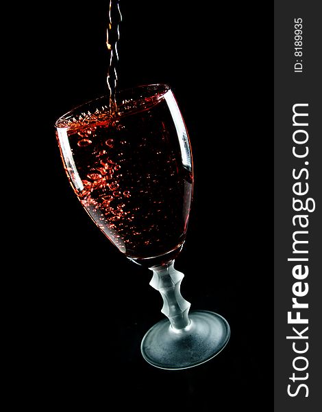 Glass of wine on a black background