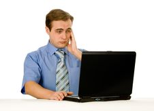 Tired Man Working On A Laptop. Isolated On White. Royalty Free Stock Images Tired Man Working On A Laptop. Isolated On White. Royalty Free Stock Images