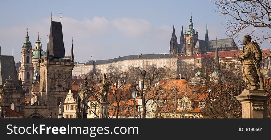 Prague winter panorama with Charles bridge towers, st. Nicholas church and Prague castle.