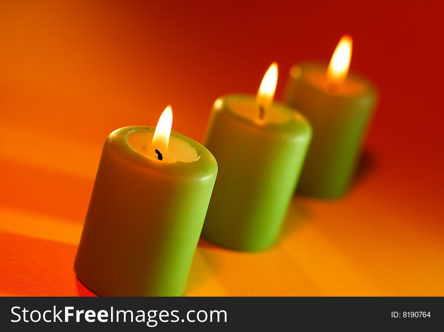 Green candles on orange background