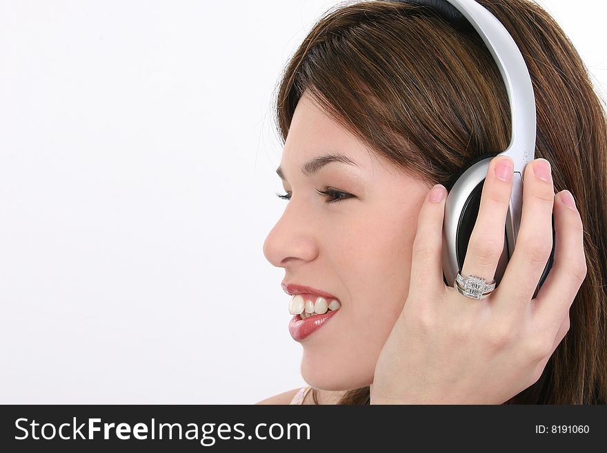 Beautiful Hispanic woman listening to audio over headphones. Beautiful Hispanic woman listening to audio over headphones.