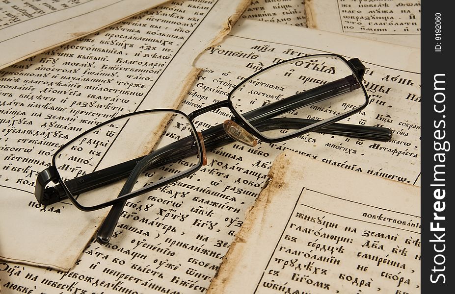 Glasses on the  old book pages