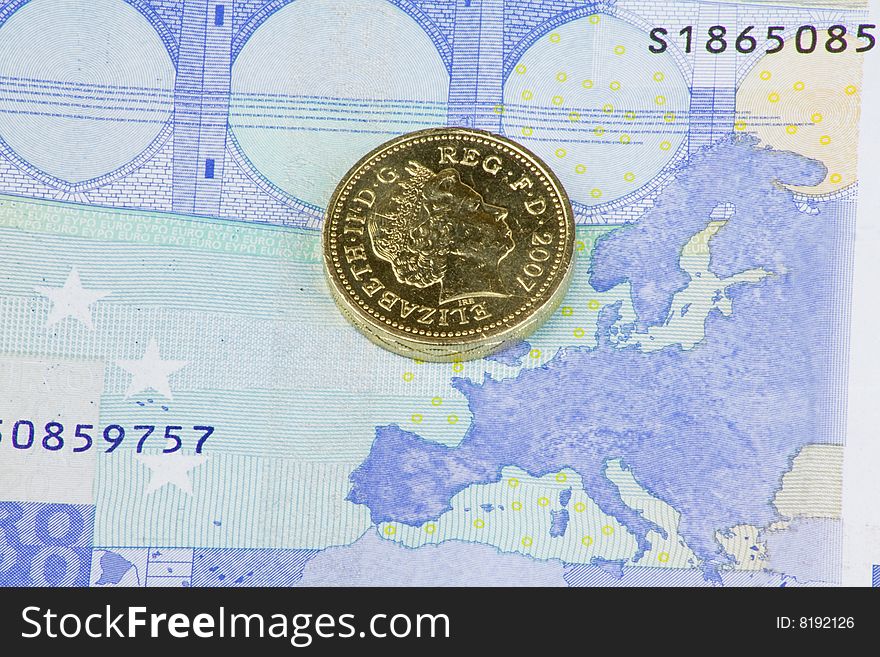 British pound coin on a twenty euro note showing the map of europe. British pound coin on a twenty euro note showing the map of europe