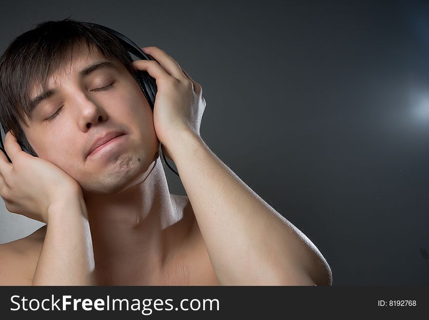 Young man enjoying his music, Young man with headphones, listening to music. Young man enjoying his music, Young man with headphones, listening to music