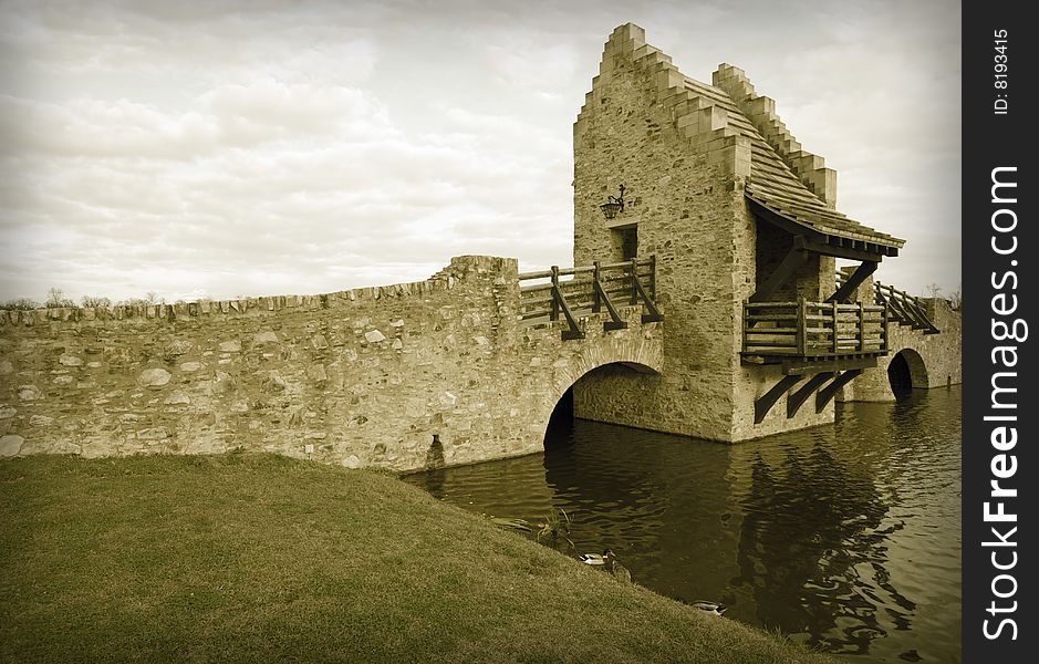 Colorized Ancient Medieval Raplica Bridge Over River Water.